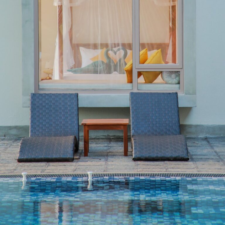 Two pool chairs by the pool at Ona Garden Villa