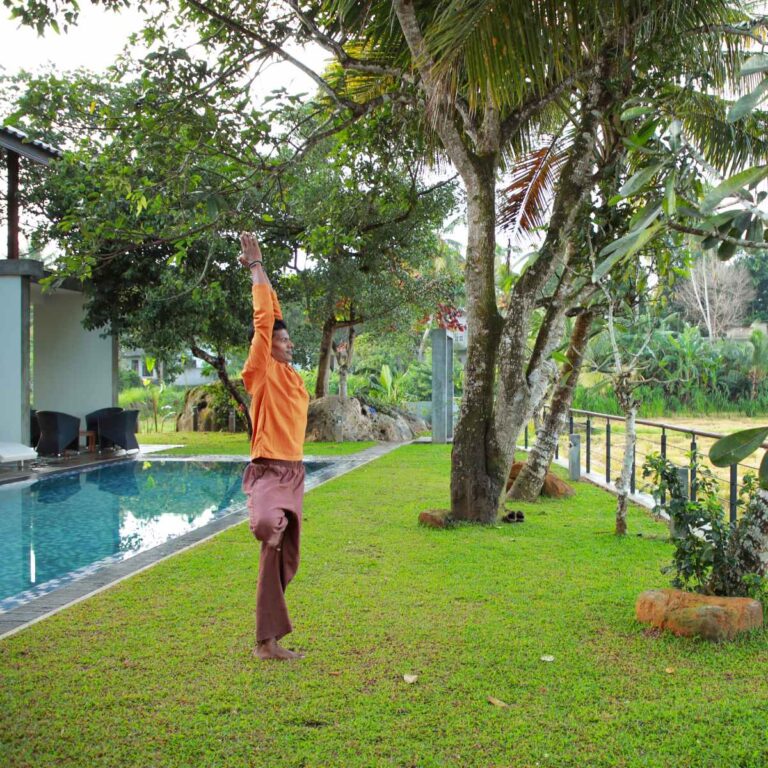 A guest doing yoga by the pool at Ona Garden Villa