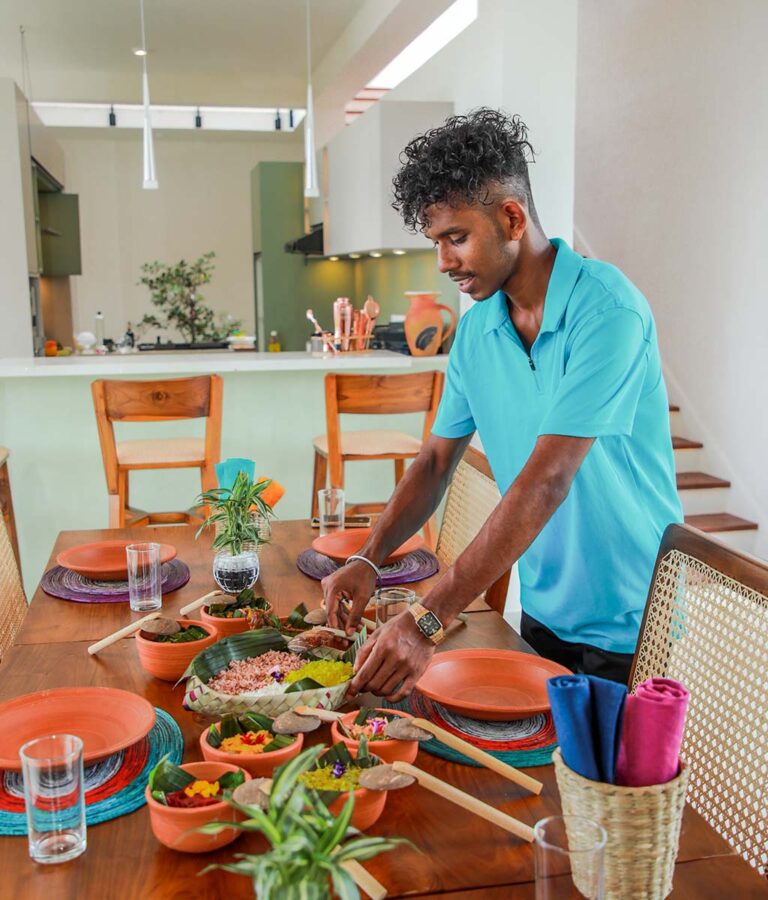 A worker arranging a dinner table