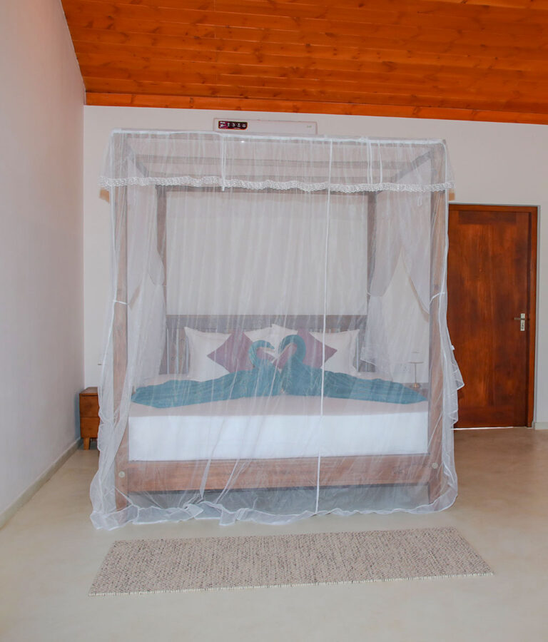Close-up of a four-poster bed at Ona Garden Villa