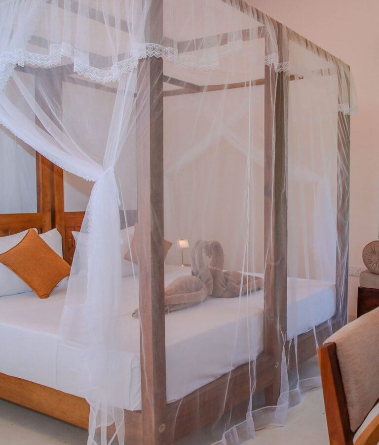 Four poster bed in a room at Ona Garden Villa