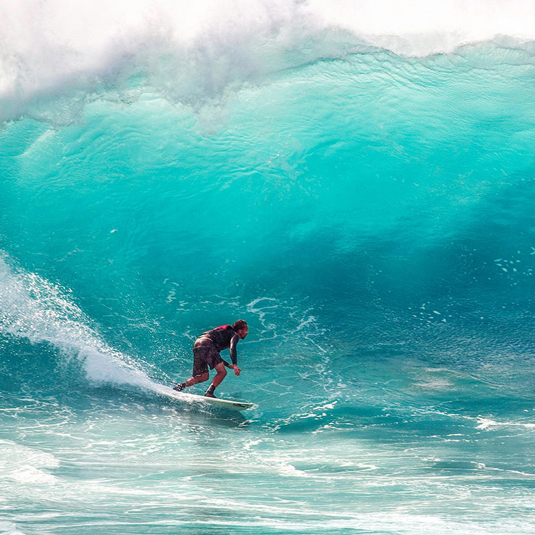Surfer surfing with a large wave