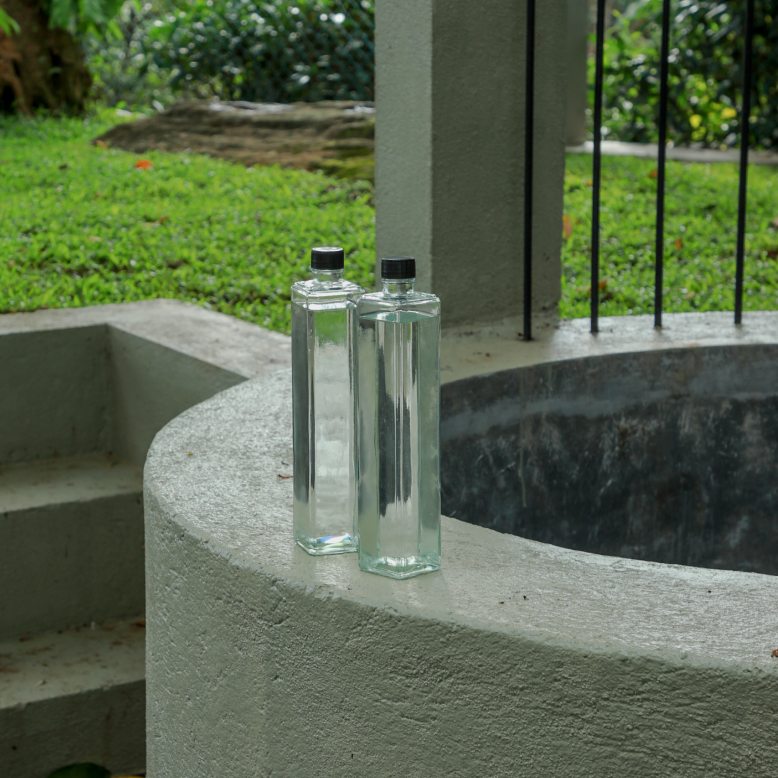Two glass bottles on the well wall